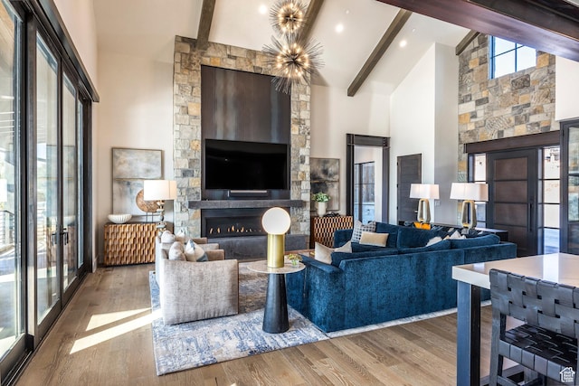 149 N Haystack Mountain Dr, Heber City, UT 84032 - living room with high vaulted ceiling, wood finished floors, beam ceiling, a glass covered fireplace, and radiator heating unit