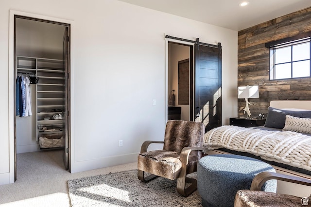 149 N Haystack Mountain Dr, Heber City, UT 84032 - carpeted bedroom featuring a barn door, wooden walls, a walk in closet, a closet, and recessed lighting