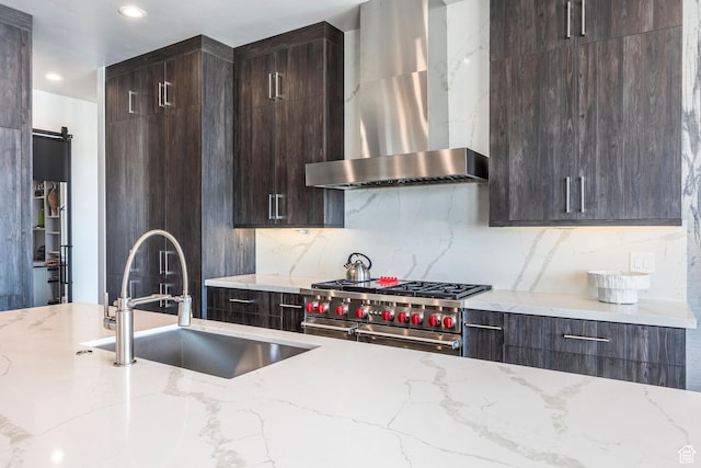 149 N Haystack Mountain Dr, Heber City, UT 84032 - kitchen with wall chimney exhaust hood, stainless steel stove, a sink, dark brown cabinetry, and recessed lighting