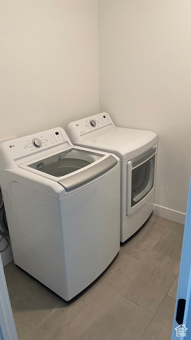 clothes washing area featuring independent washer and dryer