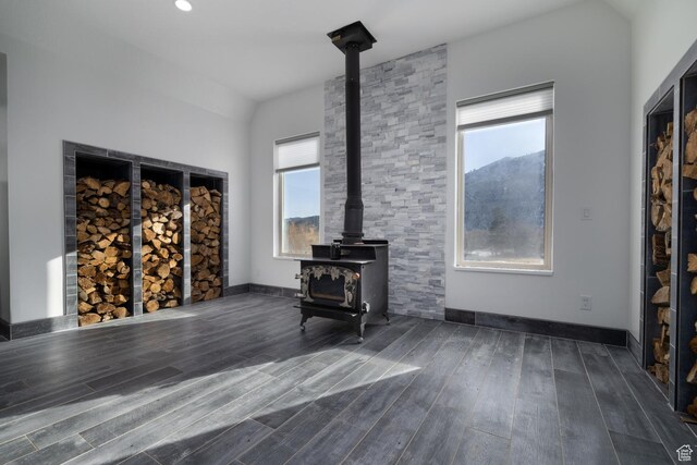 7748 W Mountain Dell Dr, Vernal, UT 84078 - unfurnished living room with a mountain view, plenty of natural light, dark hardwood / wood-style floors, and a wood stove