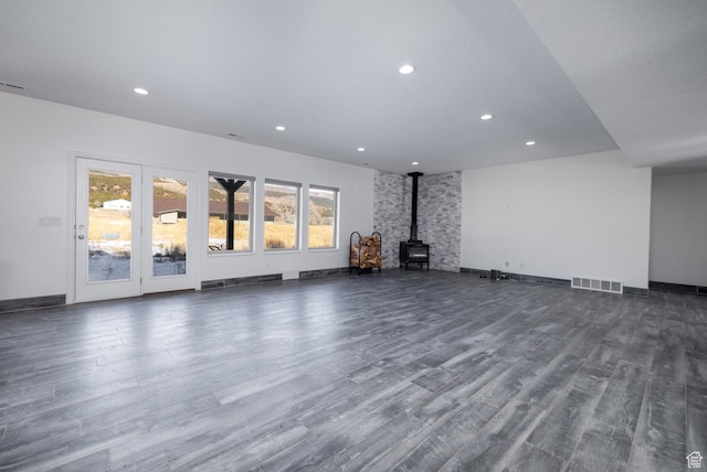 7748 W Mountain Dell Dr, Vernal, UT 84078 - unfurnished living room with dark wood-type flooring and a wood stove