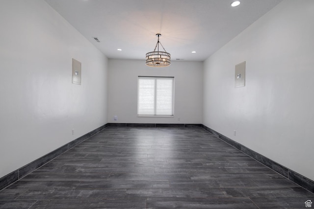 7748 W Mountain Dell Dr, Vernal, UT 84078 - unfurnished room featuring dark hardwood / wood-style floors and a chandelier