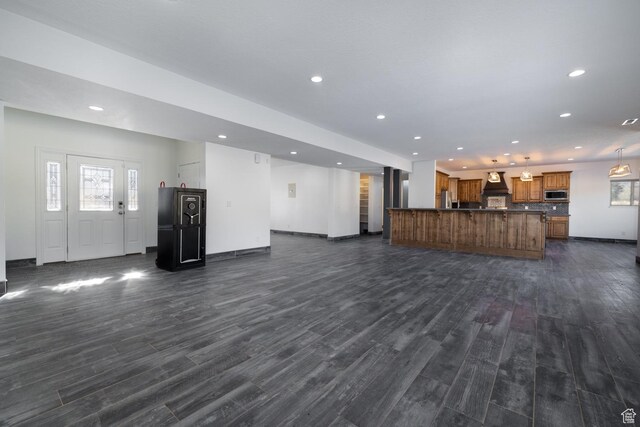 7748 W Mountain Dell Dr, Vernal, UT 84078 - unfurnished living room featuring dark hardwood / wood-style floors