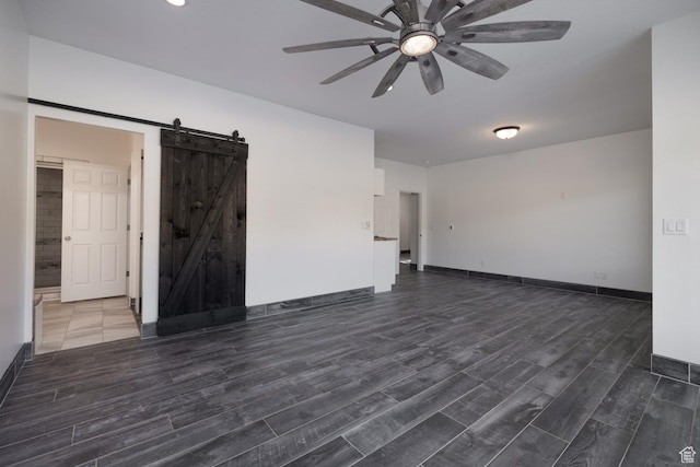 7748 W Mountain Dell Dr, Vernal, UT 84078 - empty room featuring dark wood-type flooring, a barn door, and ceiling fan