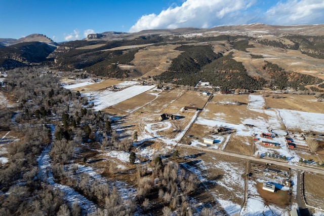 7748 W Mountain Dell Dr, Vernal, UT 84078 - snowy aerial view with a mountain view