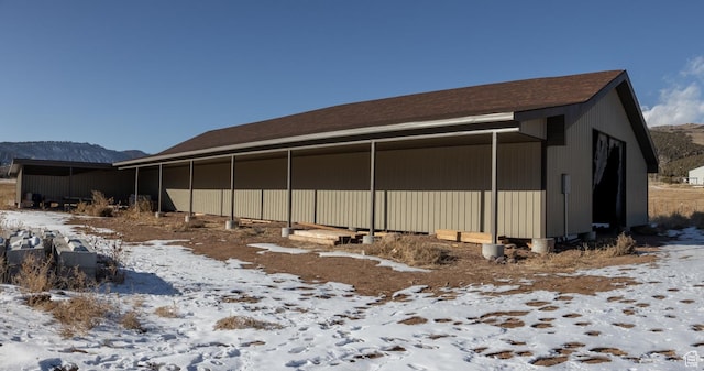 7748 W Mountain Dell Dr, Vernal, UT 84078 - view of snowy exterior with a mountain view and an outdoor structure