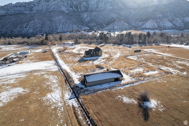 7748 W Mountain Dell Dr, Vernal, UT 84078 - snowy aerial view with a mountain view and a rural view