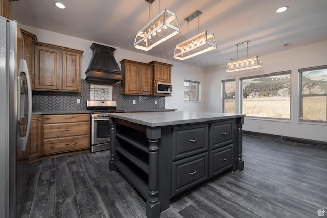 7748 W Mountain Dell Dr, Vernal, UT 84078 - kitchen with premium range hood, dark wood-type flooring, a center island, hanging light fixtures, and appliances with stainless steel finishes