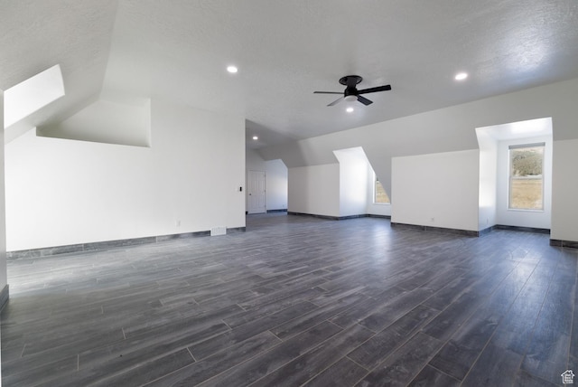 7748 W Mountain Dell Dr, Vernal, UT 84078 - interior space with dark wood-type flooring, ceiling fan, vaulted ceiling, and a textured ceiling