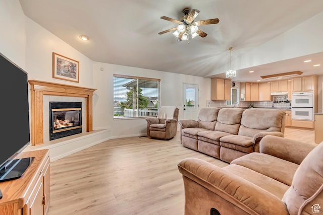 12159 S Swensen Cir, Riverton, UT 84096 - living room with vaulted ceiling, ceiling fan, light wood finished floors, baseboards, and a fireplace