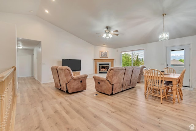 12159 S Swensen Cir, Riverton, UT 84096 - living area with vaulted ceiling, a ceiling fan, light wood finished floors, recessed lighting, and a glass covered fireplace