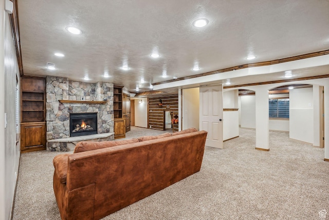 12159 S Swensen Cir, Riverton, UT 84096 - carpeted living room featuring ornamental molding, arched walkways, recessed lighting, baseboards, and a fireplace