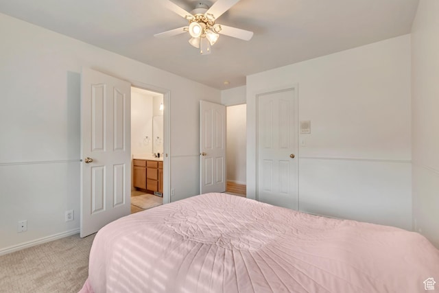 12159 S Swensen Cir, Riverton, UT 84096 - bedroom with baseboards, light colored carpet, ensuite bathroom, and ceiling fan