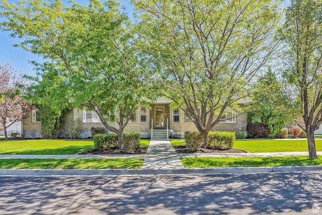 12159 S Swensen Cir, Riverton, UT 84096 - obstructed view of property featuring a front lawn and brick siding