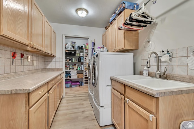 12159 S Swensen Cir, Riverton, UT 84096 - laundry area with cabinet space, washer and clothes dryer, and light wood-style flooring