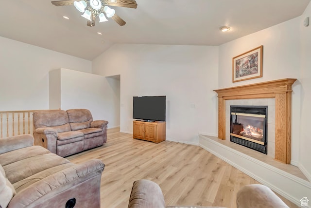 12159 S Swensen Cir, Riverton, UT 84096 - living room featuring a ceiling fan, light wood-type flooring, vaulted ceiling, a tiled fireplace, and recessed lighting
