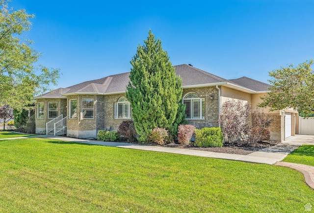 view of front of home featuring a garage and a front lawn