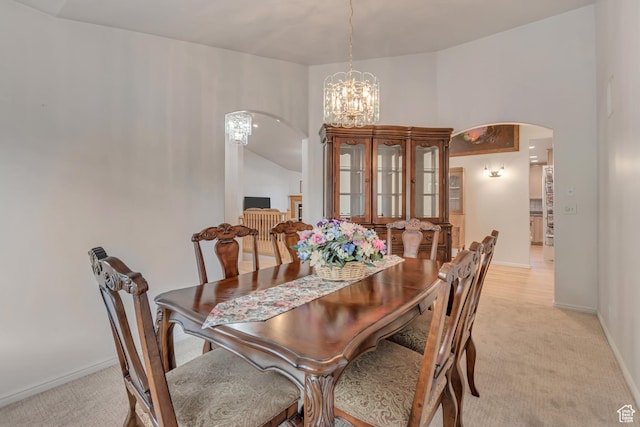 12159 S Swensen Cir, Riverton, UT 84096 - dining space featuring arched walkways, light colored carpet, a chandelier, and baseboards