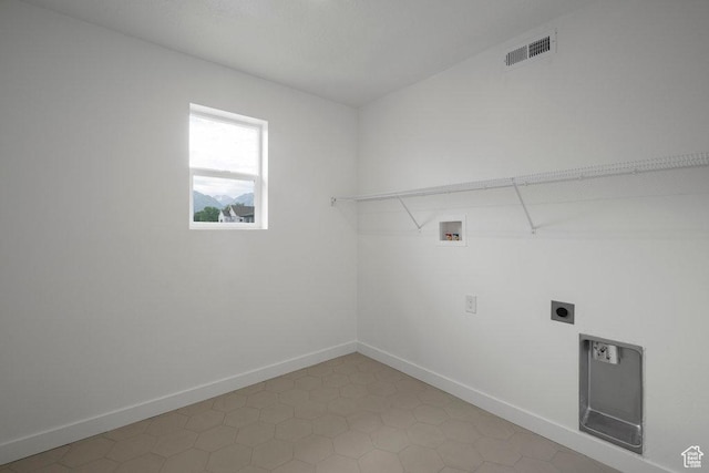 clothes washing area featuring hookup for a washing machine, hookup for an electric dryer, and baseboards