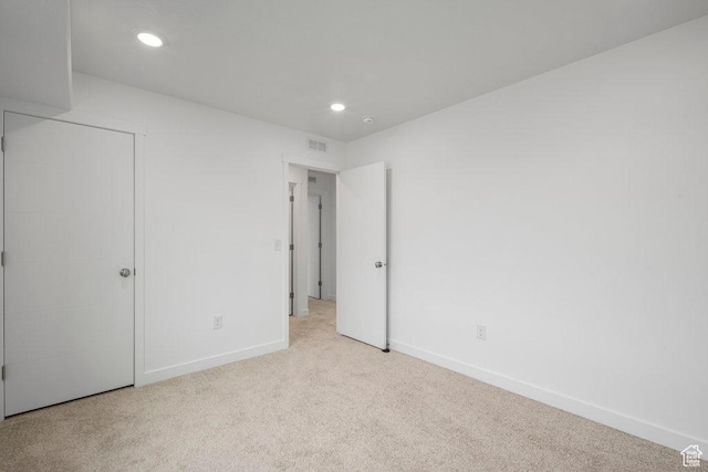 unfurnished bedroom featuring carpet, baseboards, and recessed lighting