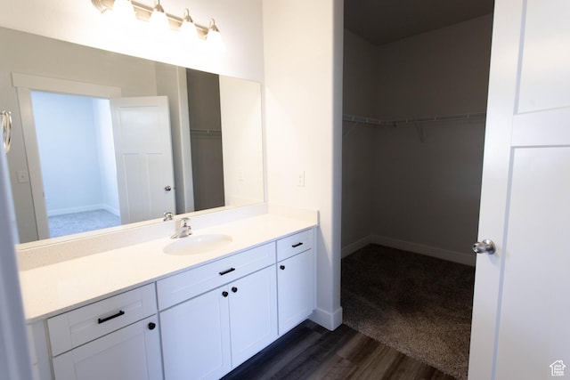 1454 N 3830 W Unit D201, Lehi, UT 84043 - bathroom featuring vanity, baseboards, wood finished floors, and a spacious closet