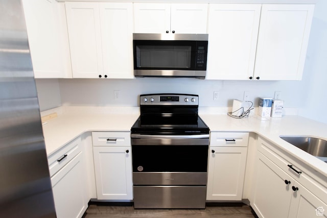 1454 N 3830 W Unit D201, Lehi, UT 84043 - kitchen with light countertops, appliances with stainless steel finishes, white cabinets, and dark wood-style floors