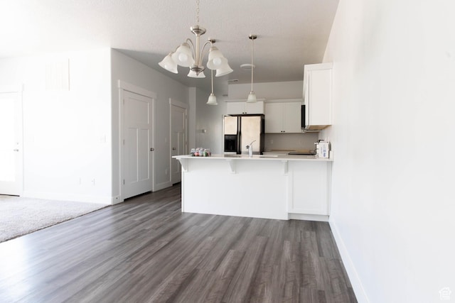 1454 N 3830 W Unit D201, Lehi, UT 84043 - kitchen with fridge with ice dispenser, white cabinets, a peninsula, dark wood-style floors, and an inviting chandelier