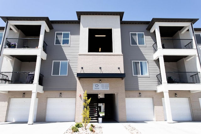 1454 N 3830 W Unit D201, Lehi, UT 84043 - view of property featuring an attached garage and driveway