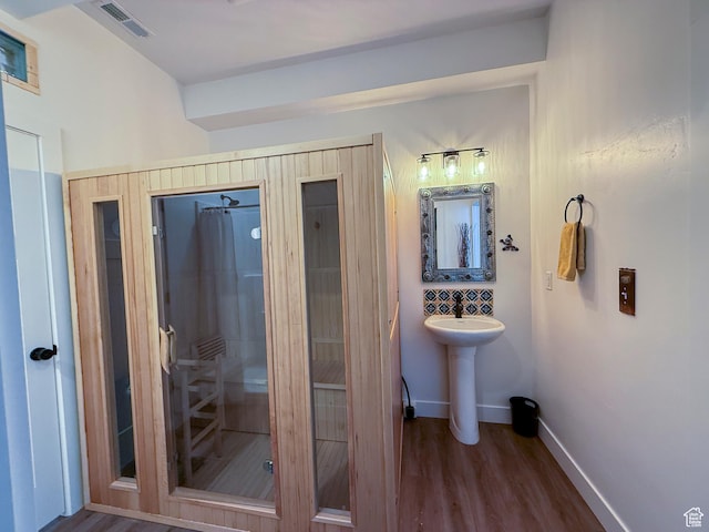 1610 N Mackinaw Way, Garden City, UT 84028 - bathroom with a stall shower, baseboards, visible vents, and wood finished floors
