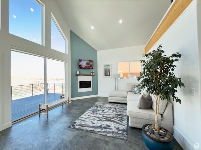 1610 N Mackinaw Way, Garden City, UT 84028 - living room featuring high vaulted ceiling, visible vents, baseboards, concrete floors, and a fireplace