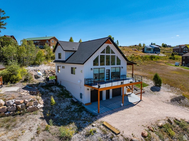 1610 N Mackinaw Way, Garden City, UT 84028 - back of house with driveway, a patio, and a deck