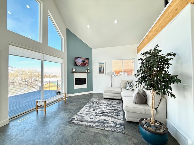 1610 N Mackinaw Way, Garden City, UT 84028 - living room featuring baseboards, visible vents, high vaulted ceiling, and a fireplace