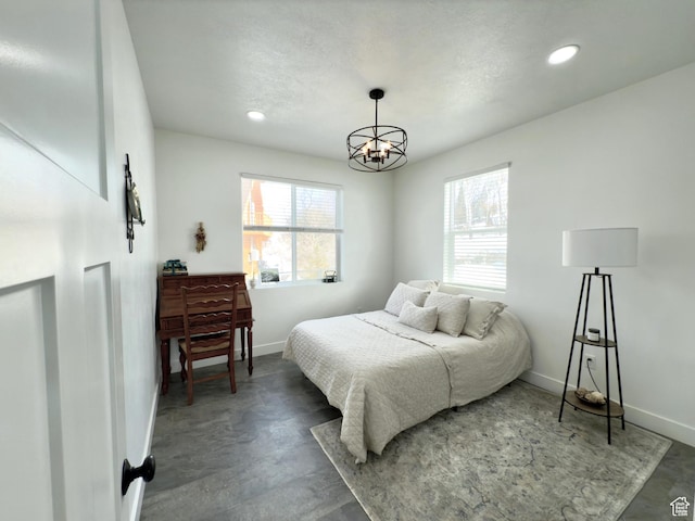 1610 N Mackinaw Way, Garden City, UT 84028 - bedroom with finished concrete flooring, baseboards, a chandelier, and recessed lighting