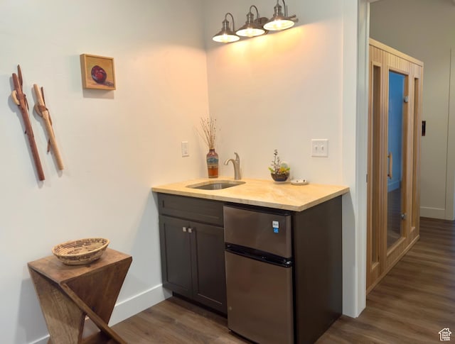 1610 N Mackinaw Way, Garden City, UT 84028 - interior space with baseboards, wet bar, a sink, dark wood-style floors, and freestanding refrigerator