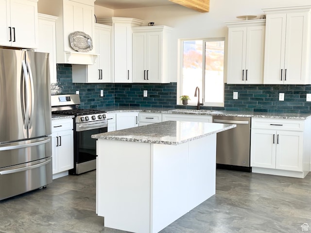 1610 N Mackinaw Way, Garden City, UT 84028 - kitchen featuring premium range hood, a sink, tasteful backsplash, and appliances with stainless steel finishes