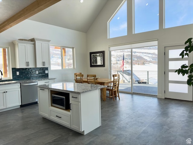 1610 N Mackinaw Way, Garden City, UT 84028 - kitchen featuring decorative backsplash, a sink, light stone counters, white cabinets, and appliances with stainless steel finishes