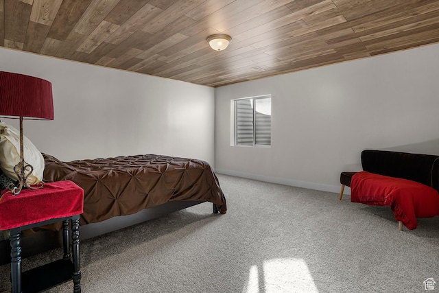 bedroom with carpet, wooden ceiling, and baseboards