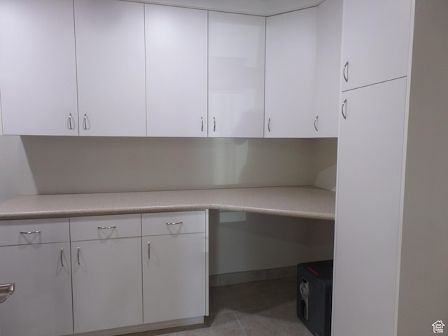 kitchen with white cabinetry and light tile patterned floors