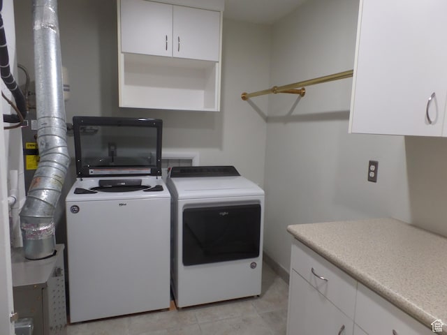 laundry room featuring washing machine and dryer and light tile patterned floors