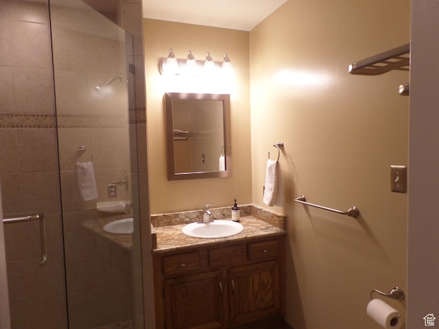 bathroom featuring vanity and a shower with shower door