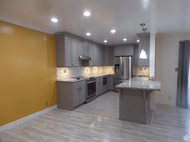 kitchen featuring a breakfast bar, gray cabinetry, decorative light fixtures, kitchen peninsula, and stainless steel appliances
