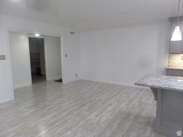 5566 S Springtree Ln E Unit A, Murray, UT 84107 - unfurnished living room featuring crown molding, light wood-style flooring, and baseboards