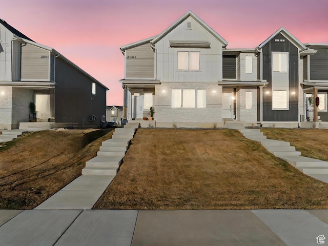 view of front of home with a lawn