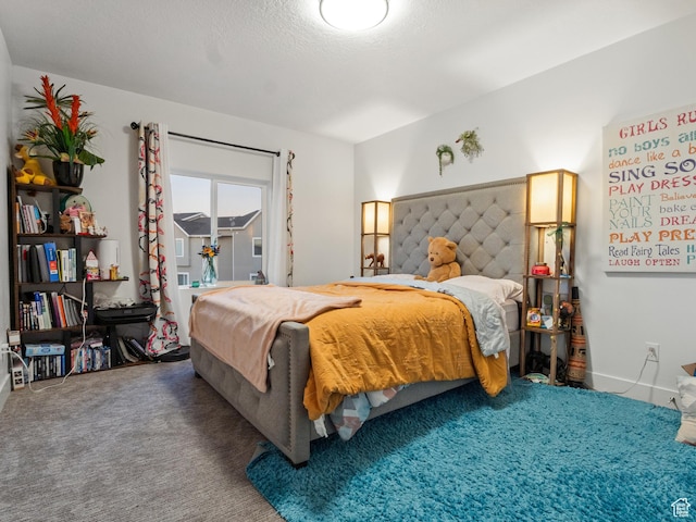 bedroom featuring carpet floors and a textured ceiling