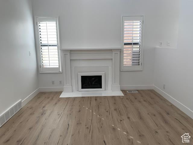 unfurnished living room with light hardwood / wood-style floors