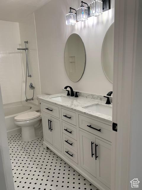 full bathroom with vanity, toilet, and washtub / shower combination