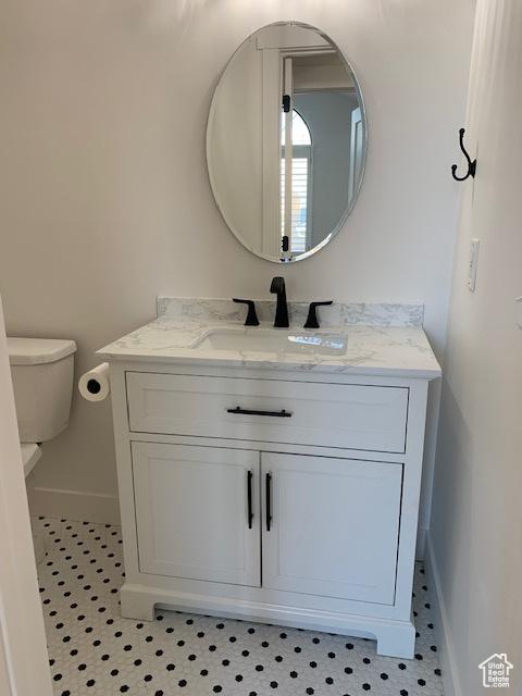 bathroom featuring vanity and toilet