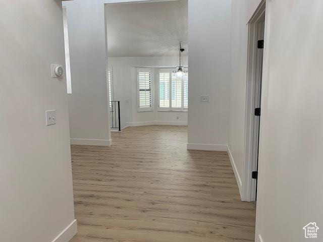 corridor with light hardwood / wood-style floors