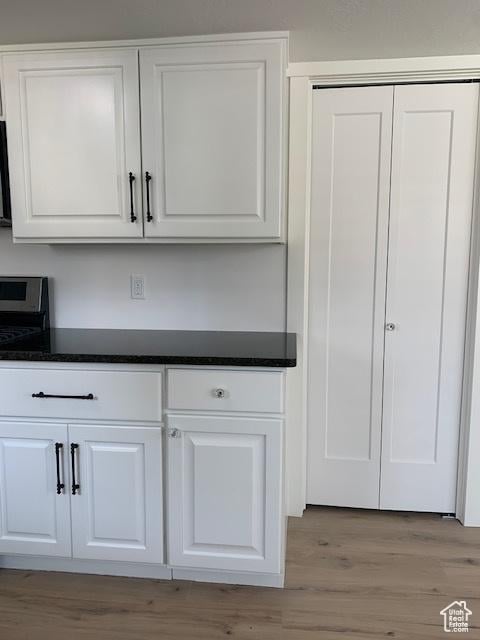 interior details featuring hardwood / wood-style flooring and stainless steel electric stove